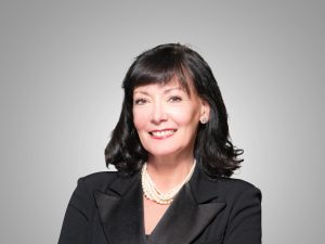 Leslie Muldowney wearing a black top and black blazer.